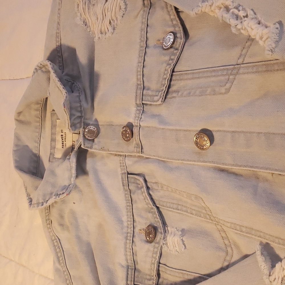 Light wash blue distressed denim jacket
